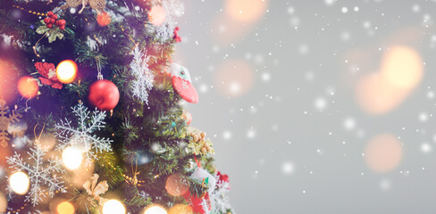 Merry Christmas 2020 and happy new year 2021 concept,Christmas holiday background. Red bauble hanging from a decoration on tree with bokeh and snow,copy space.