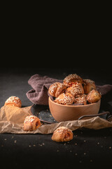 Small meat pies with sesame on dark background