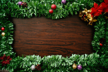 Fototapeta na wymiar green christmas frame with wooden background