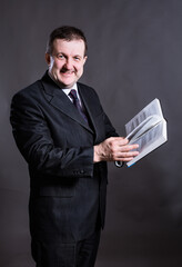 Middle aged solid tutor with book studio portrait.