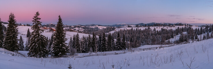 Small and quiet alpine village and winter sunrise snowy mountains around, Voronenko, Carpathian, Ukraine.