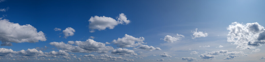Naklejka na ściany i meble Blue sky with clouds in sunshine (wide natural cloudscape background panorama)