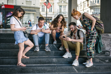 Group of friends using smartphones together. Young people addiction to new technology trends. Youth, new generation internet friendship concept. Emotional isolation and depresion