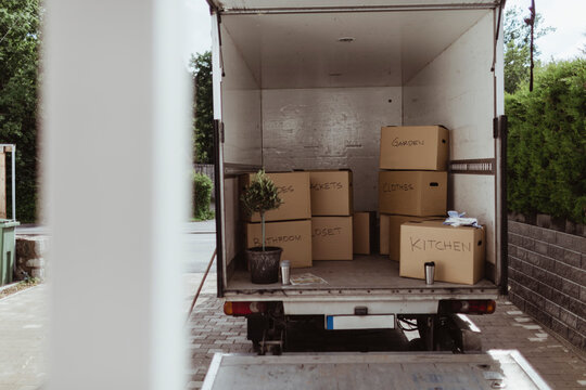 Cardboard Boxes Arranged In Back Of Moving Truck