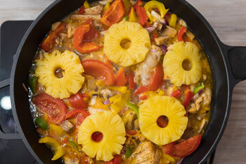 Pineapples with chicken meat in vegetables. Culinary background with selective focus