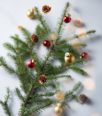 Christmas gray background with fir branches, cones and Christmas toys.
