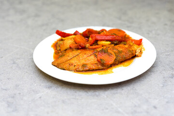Chraime on marble table. Chraime - shabbat fish simmered in hot tomato sauce, garlic, pepper, lemon and spices. Traditional Libyan, Moroccan, Jewish, Sephardic, Arabian dish.