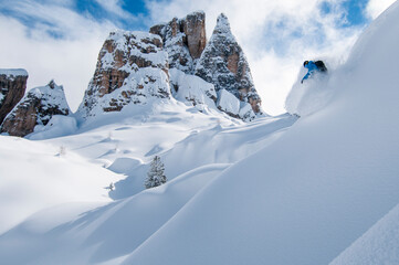 Man snowboarding on snow covered mountains