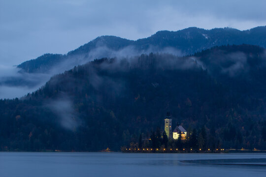 View of Pilgrimage Church of the Assumption of Maria by Lake Bled during sunset