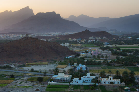 Scenic view of town with mountains in background