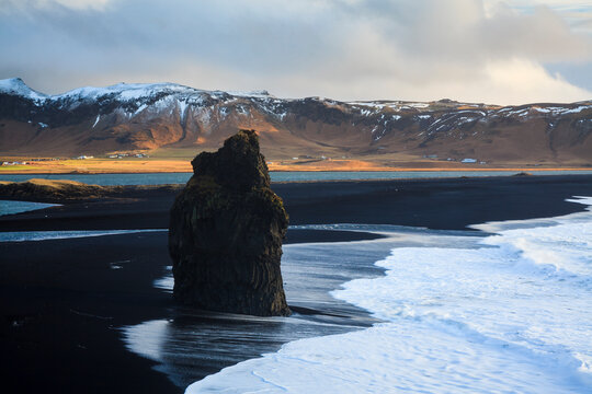 Scenic view of beach with volcanic black sand