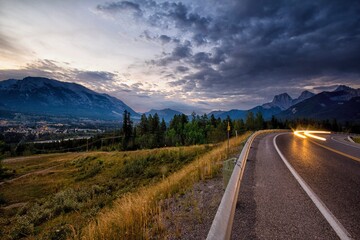 View of light trail on road with mountains in background