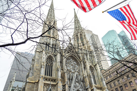 Saint Patrick's Cathedral Church in Manhattan, New York City, USA. External View of Catholic Cathedral in Manhattan. US Flags Waving Proudly. Low Angle View Photography.