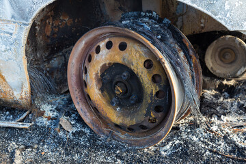 Burned down car, abstract background, selective focus. The situation of protests in the world.