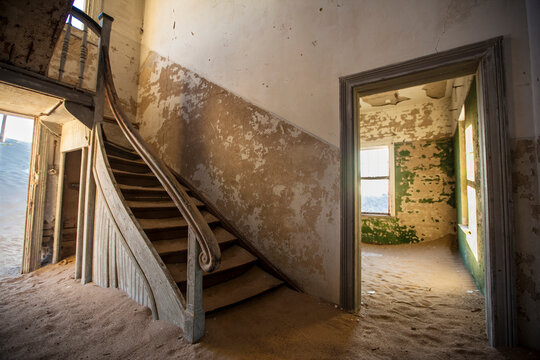 Interior view of abandoned sand filled house of ghost town