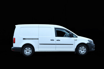 Driving white new mini van for delivery isolated on dark background cargo car