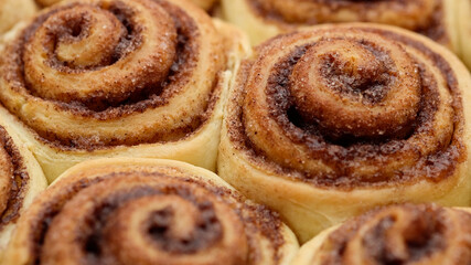 Freshly baked cinnamon rolls or Cinnabon close up, top view