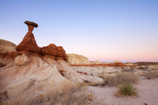 Scenic view of rock formations on desert landscape during sunset