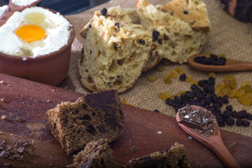 rustic table with panettone and ingredients. eggs and flour