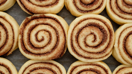 cooking cinnamon rolls or Cinnabon close up. raw cinnamon buns top view