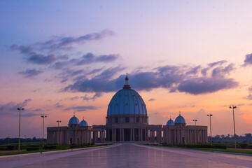 Scenic view of Basilica of Our Lady of Peace against cloudy sky at dusk