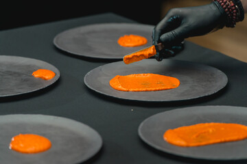 Pumpkin puree on dark grey ceramic plate