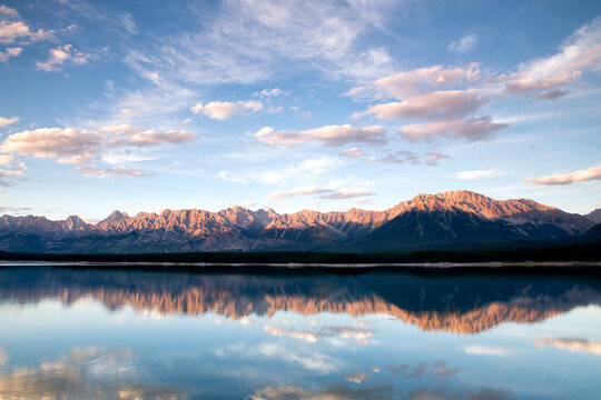 Scenic view of mountain range and Lower Kananaskis Lake during sunset