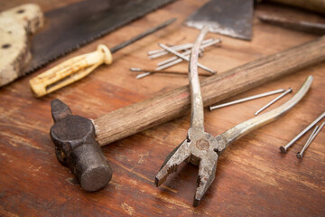 Old rusty tools on wooden grunge rough background