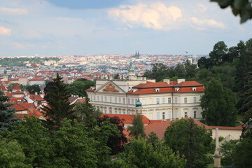 A resplendent Palace with a beautiful panoramic view of Prague on a cloudy hot day