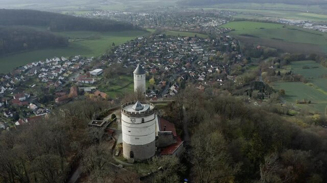 The fairytale castle burg Plesse in Bovenden near G&ouml;ttingen Goettingen at sunrise, Lower Saxony, Germany. Drone aerial shot of the Plesseburg in late autumn.