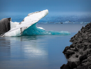 A giant blue iceberg floats in the glacial lagoon in Iceland. 