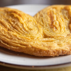 a croissant on a wooden board.