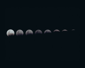 Closeup detailed shot of different phases of the moon in a dark night sky