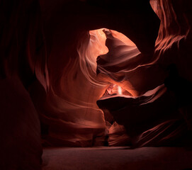  A beam of light shines down in Antelope Canyon, Arizona. A guided tour through a slot canyon on...