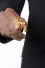 Close up of businessman holding an antique brass skeleton key.
