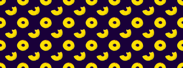 Seamless pattern of yellow whole and bitten donuts on a blue background.