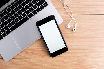 Top view of designer workplace with mock up smartphone on table.