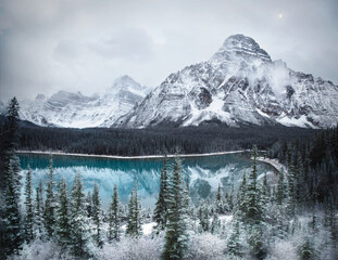 Waterfowl Lake, Banff National Park, Alberta Canada in winter. A winter landscape with a bright blue lake, snowy peaks and frosty trees. A winter wonderland.