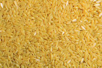 Background texture of yellow depilatory wax. Depilation wax granules. Epilation, depilation, unwanted hair removal. Top view. Place for text.