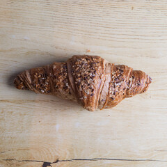 homemade croissant with seeds and on a wooden board