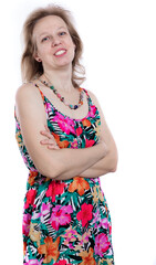 Cheerful 40 years old woman in bright dress studio portrait on white background.