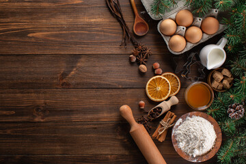 Fototapeta na wymiar Culinary background for homemade Christmas baking. Fresh and healthy ingredients for gingerbread cookies on a wooden background, top view, copy space.