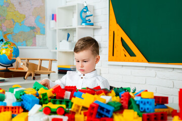 Children in kindergarten. Schoolboy boy studies at home and does school homework.