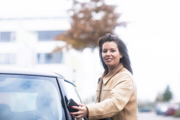 young woman using a car as carsharing