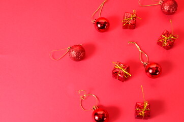 Christmas background with decorations and gift boxes on red background