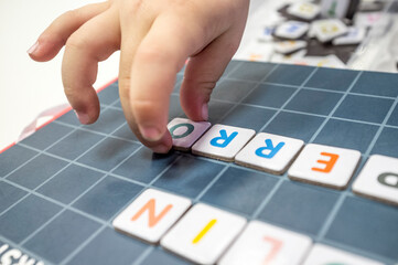 Child practices with word formation board game