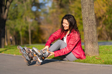 Active leisure. A sportive girl is rollerblading in an autumn park