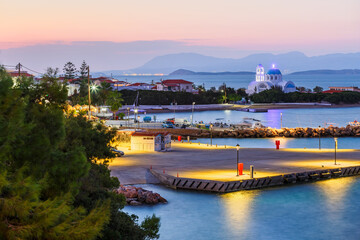 Harbour and a church in Skala village on Agistri island, Greece.