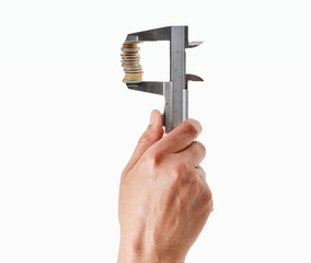 Closeup shot of a man holding  clamp and stack of coins isolated on white background.