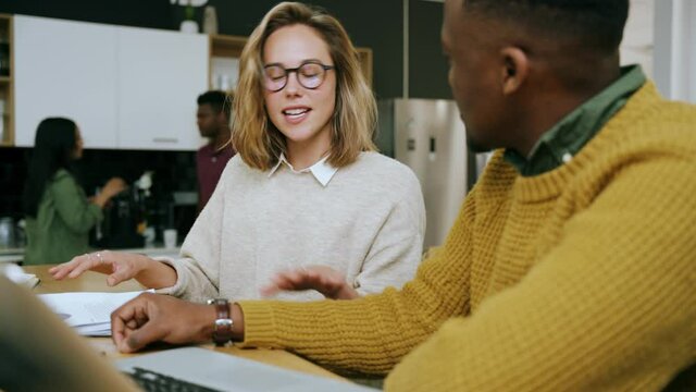 Caucasian business woman brainstorming with ethnic male colleague ideas for new essay assignment 